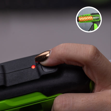 Close-up of a hand holding a green and black device with a small inset showing a close-up of the device's interior.